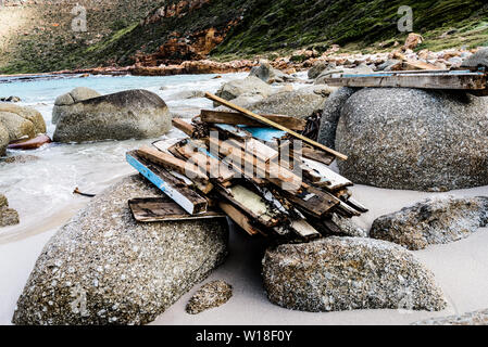 Driftwood is stacked on the rocks to dry at South Africa's Smitswinkel Bay on the Cape Peninsula's False Bay coastline, near the city of Cape Town Stock Photo