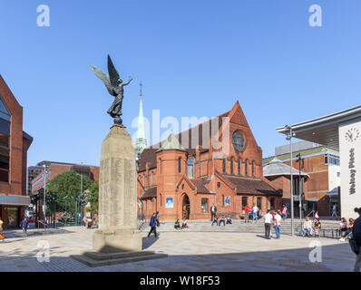 Christ Church and war memorial in Jubilee Square in Woking, Surrey, south-east England on a sunny summer day, clear blue sky Stock Photo