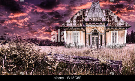 Haunted old house in a dramatic horror atmosphere with fire sky. Creepy sunset over the ancient frightful mansion in a Halloween scene. Stock Photo