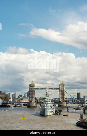 View looking east from London Bridge with Tower Bridge, HMS Belfast and The River Thames on a sunny day in the city Stock Photo