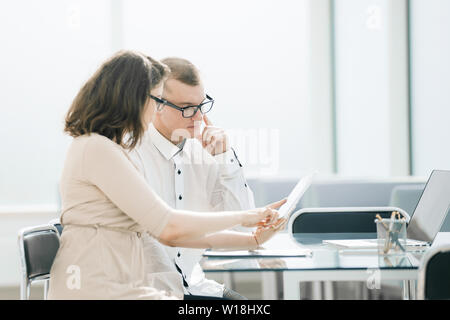 business colleagues use a digital tablet to work in the office. people and technology Stock Photo