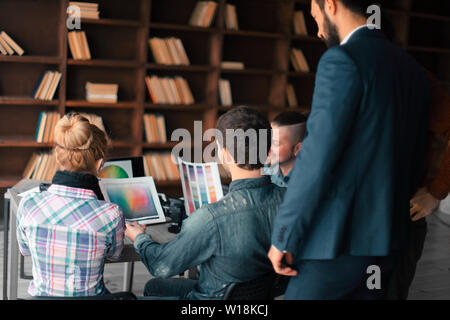 photographers discussing the color palette in the editorial. Stock Photo