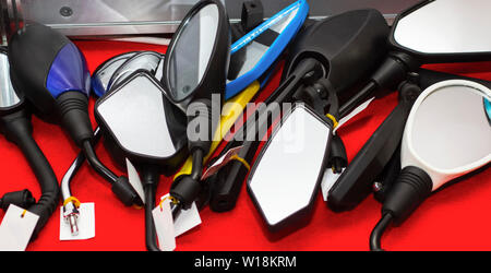 Many different mirrors for motorbike on table. Spare parts for motorbike Stock Photo