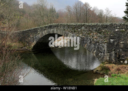 The stone Packhorse bridge at Borrowdale village, river Derwent, Derwentwater, Keswick town, Lake District National Park, Cumbria, England Stock Photo