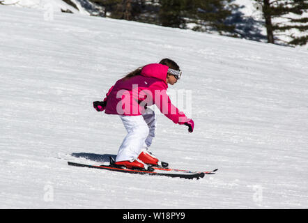 The central Pyrenees at Pont Espagne. Young girl learning to ski on the beginners slope.No sticks. Stock Photo