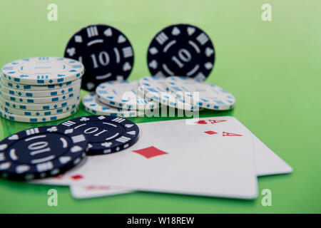 Cards and chips on green and yellow casino table. Abstract casino gambling photo. Stock Photo