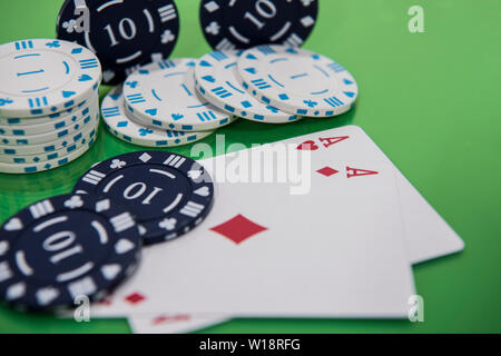 Cards and chips on green and yellow casino table. Abstract casino gambling photo. Stock Photo