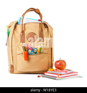 Brown school backpack full of various colorful stationery and supplies. Isolated on white background. Stock Photo