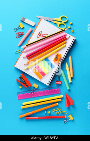 Set of various colorful school stationery and supplies on blue background. Stock Photo