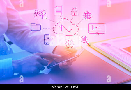 Corporate businesswoman using apps on her smartphone and interactive user interface with network of icons Stock Photo