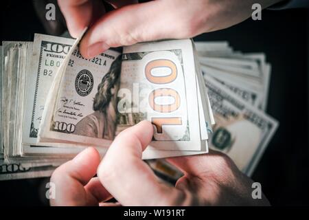 Daily Earnings Money Counting. US Dollars in Businessman Hands. Stock Photo
