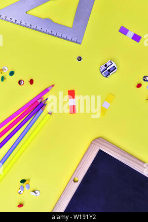 top view on suplies of school on yellow background Stock Photo