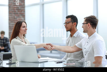 businessman and businesswoman shaking hands to confirm their deal . concept of cooperation Stock Photo