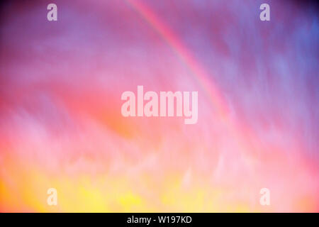 A dramatic rainbow at sunset over Ambleside during stormy weather, Lake District, UK. Stock Photo