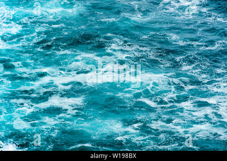 Blue sea water surface rippled with foam Stock Photo