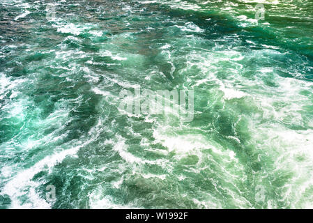 Background made from a rushing, foamy river in a beautiful turquoise and green color. Stock Photo