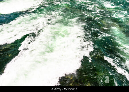 Background made from a rushing, foamy river in a beautiful turquoise and green color. Stock Photo