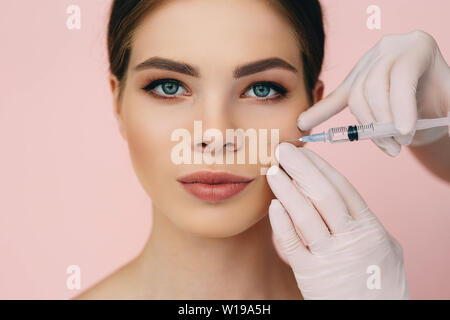 beauty injections into beautiful face. smoothing of mimic wrinkles around  the eyes using biorevitalization Stock Photo - Alamy