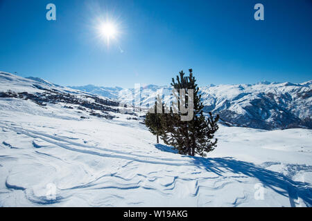 Panoramic view across snow covered alpine mountain range in alps on blue sky background Stock Photo