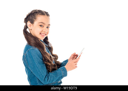happy kid in denim jacket using smartphone isolated on white Stock Photo