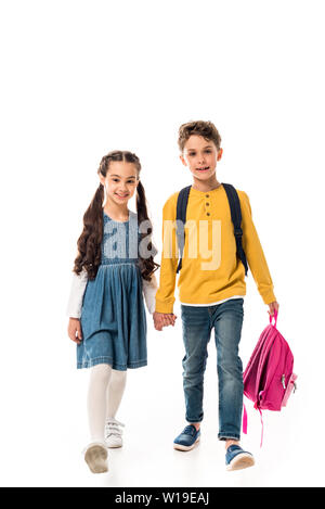 full length view of schoolchildren with backpacks holding hands isolated on white Stock Photo