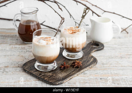 Iced coffee with vanilla ice cream and cinnamon on a light background Stock Photo