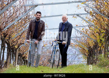 Italian former professional road bicycle racer Francesco Moser with his son Carlo, wine producer in Maso Warth vinery in Trento, Trentino Alto Adige, Stock Photo