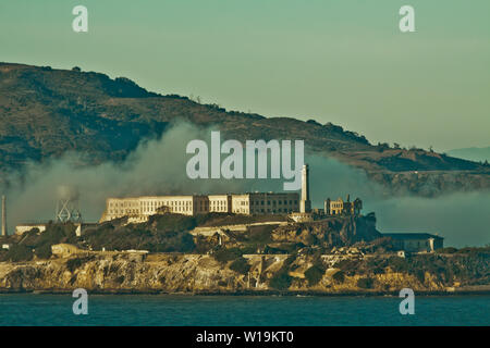 Alcatraz Island  San Francisco Bay California the home of Al Capone famous land mark taken spring morning of 2016 with the fog rolling in the bay area. Stock Photo