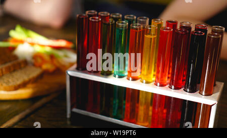 Test tubes with multi-colored liquid. Alcohol in test tubes dark bar. Photo from the bar in Lviv Ukraine Stock Photo