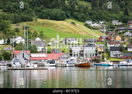 The marina surrounded by houses in the town of Norheimsund, Norway, in Hordaland County on the Hardangerfjord. Stock Photo