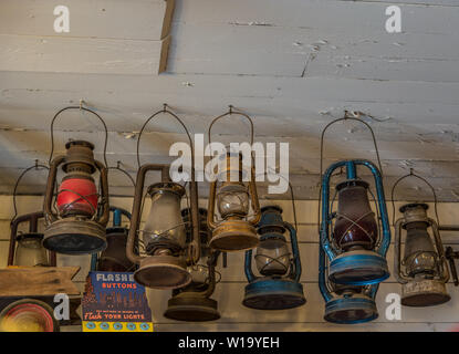 Vintage lanterns of different styles hanging on display from the ceiling in a old country store Stock Photo