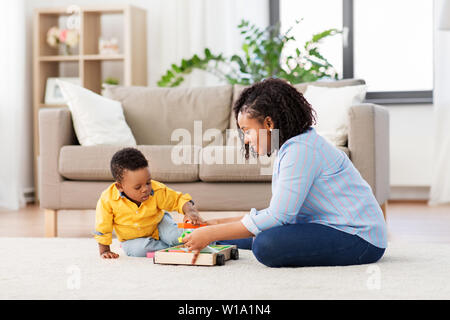 mother and baby playing with toy blocks at home Stock Photo