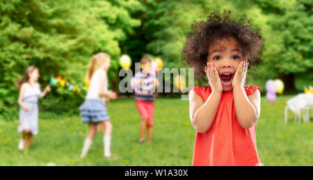 surprised african american girl at birhtday party Stock Photo