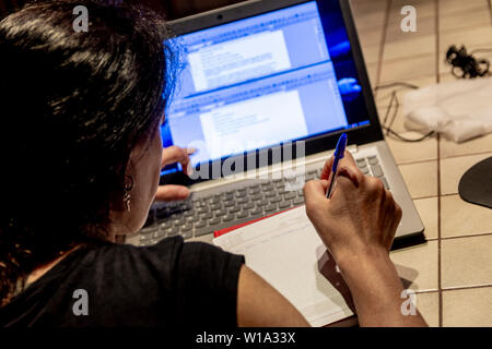 woman working with her laptop at home late at night Stock Photo