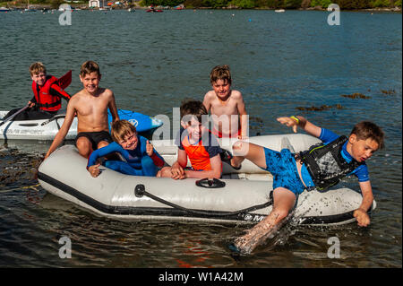 Baltimore, West Cork, Ireland. 1st July, 2019. As temperatures hit the late teens on a beautiful sunny day, tourists and locals alike took the chance to cool off in the water. A group of boys took to boats for messing about on the water. Credit: Andy Gibson/Alamy Live News. Stock Photo