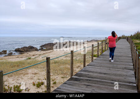 Vila Chã, Portugal - June 23, 2019 : Wooden walkway along the coast in northern Portugal, Vila do Conde, Portugal Stock Photo