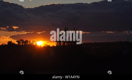 Beautiful red sun at sunset. Red sunset sky. Stock Photo