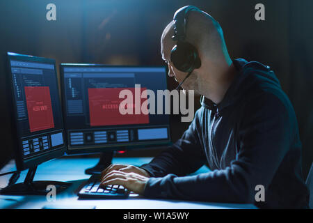 hacker with access denied messages on computers Stock Photo