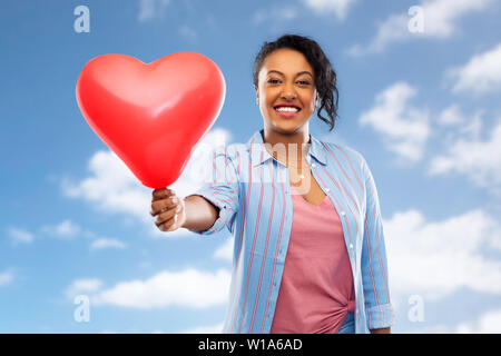 african american woman with heart-shaped balloon Stock Photo