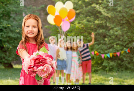 red haired girl with flowers at birthday party Stock Photo