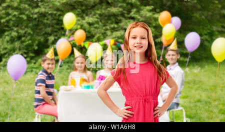 smiling red haired girl at birthday party Stock Photo