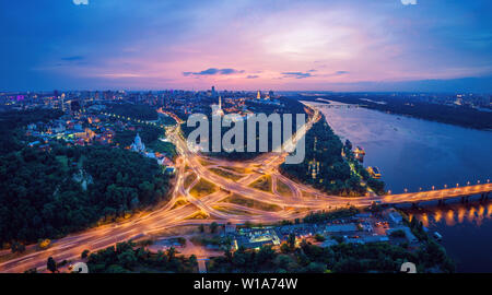 Night city panorama of the Kiev city with the Paton Bridge and the Dnieper River. Ukraine Stock Photo