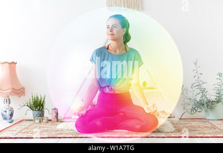 woman meditating in lotus pose at yoga studio Stock Photo