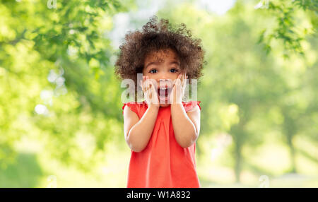 surprised little african american girl in summer Stock Photo