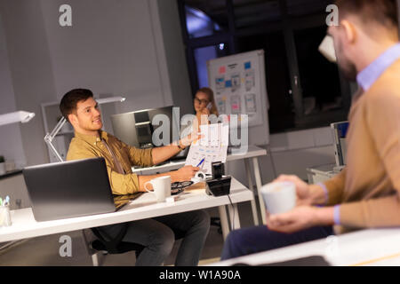 designers or software developers at night office Stock Photo