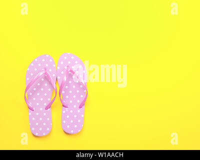 Top view image of pink flip flops on yellow background. Summer trevel and vacation concept Stock Photo