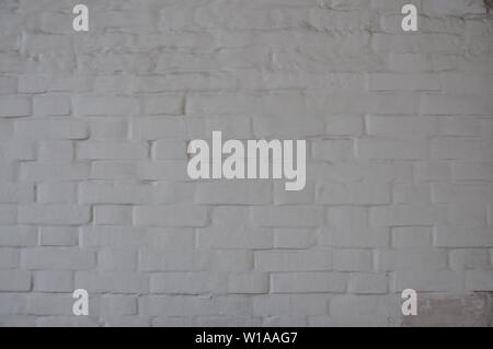 Antique white brick wall covered with paint. Stock Photo