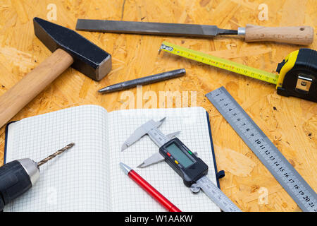 The image shows different measuring tools and tools on a wooden table Stock Photo