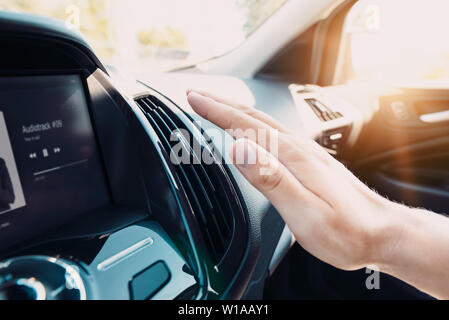 Hand checking the air conditioner in the car. The cooling system in the car Stock Photo