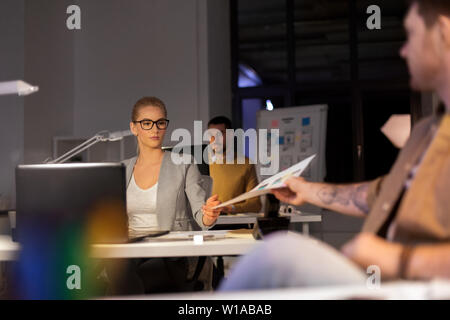 designers or software developers at night office Stock Photo